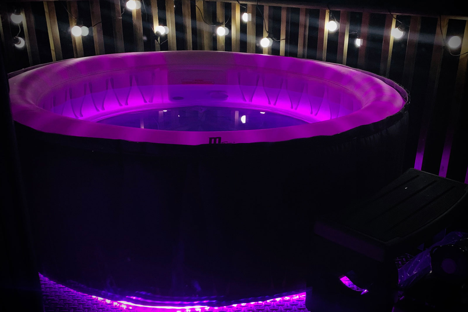 hot tub at night with purple light